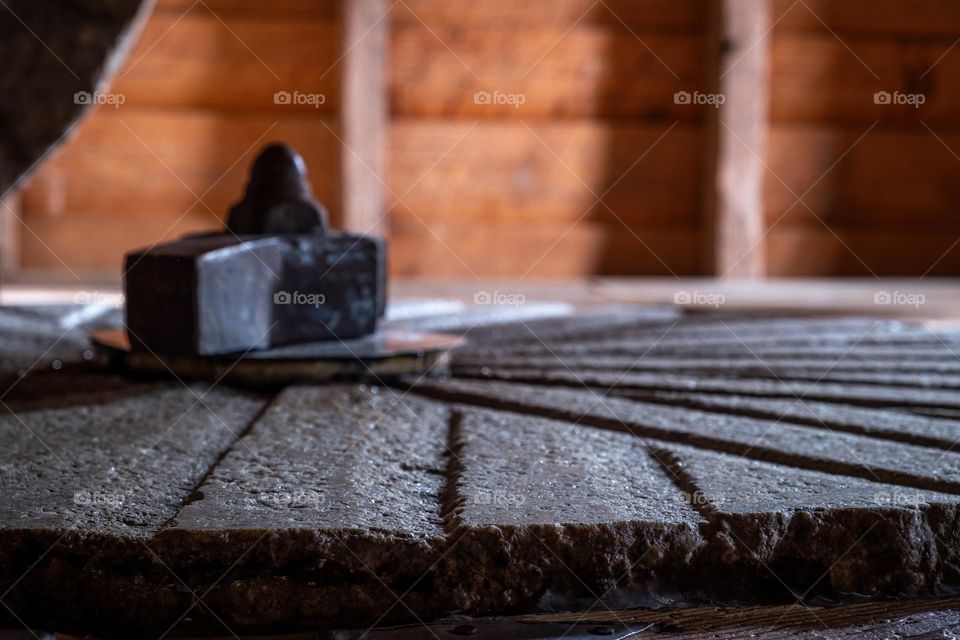 The inside story of historic Yates Mill. Close-up of the grooves of an old grinding wheel.