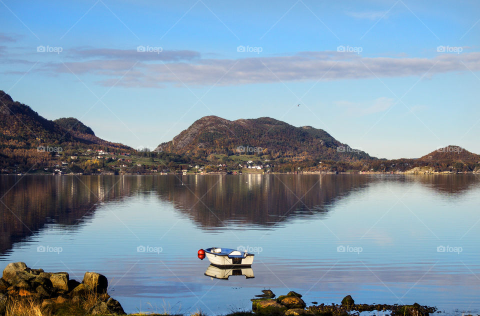 Small boat on a calm lake. 