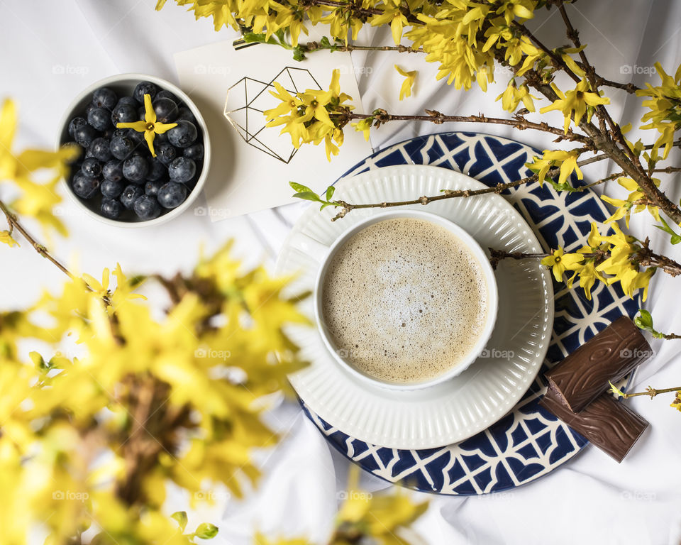 Cup of coffee with chocolates and berries 