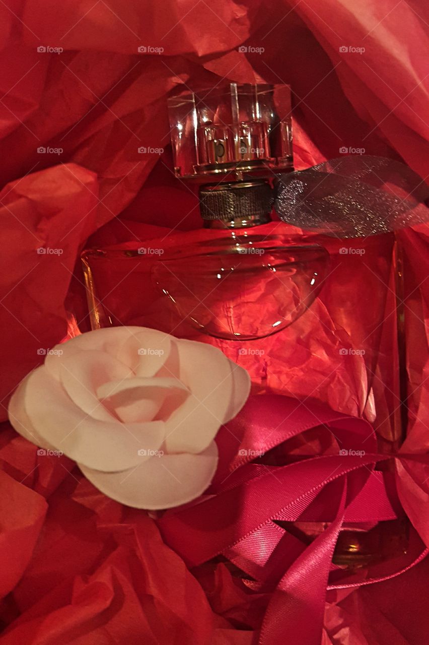 perfum and flower in red