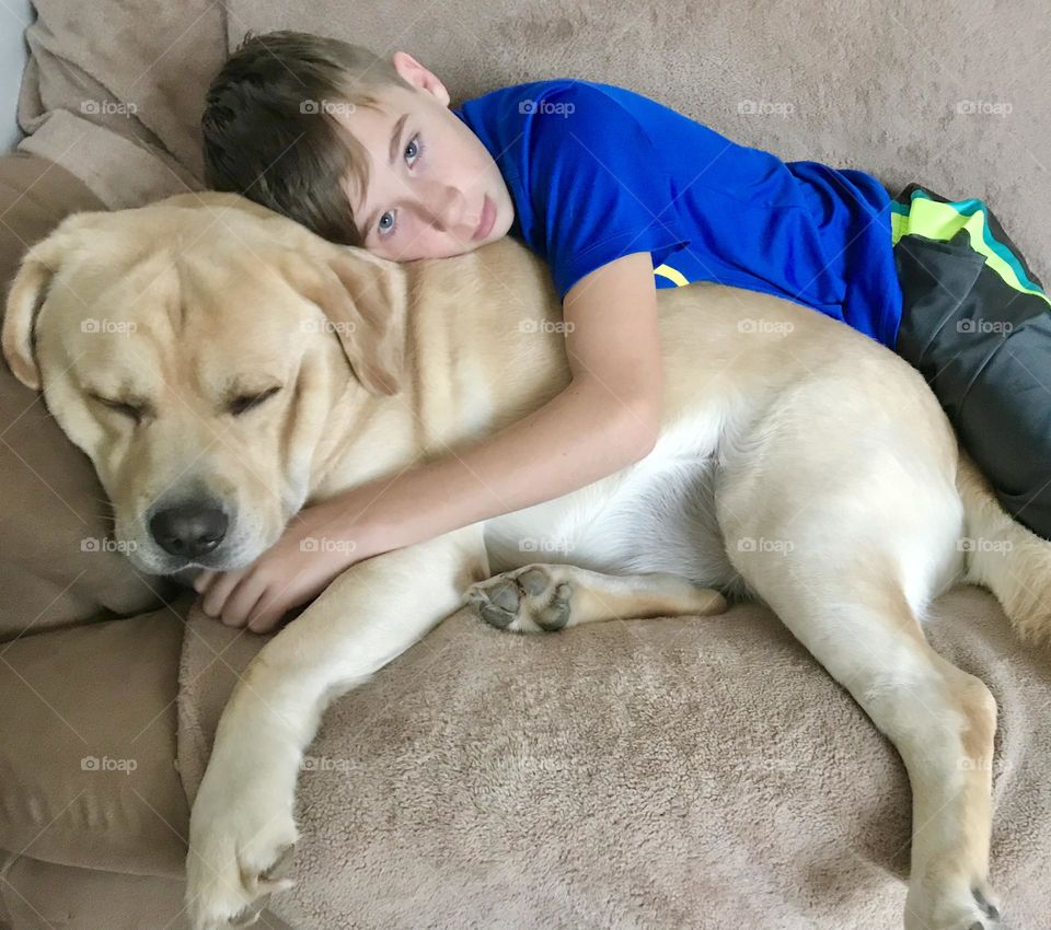 A boy resting with his dog