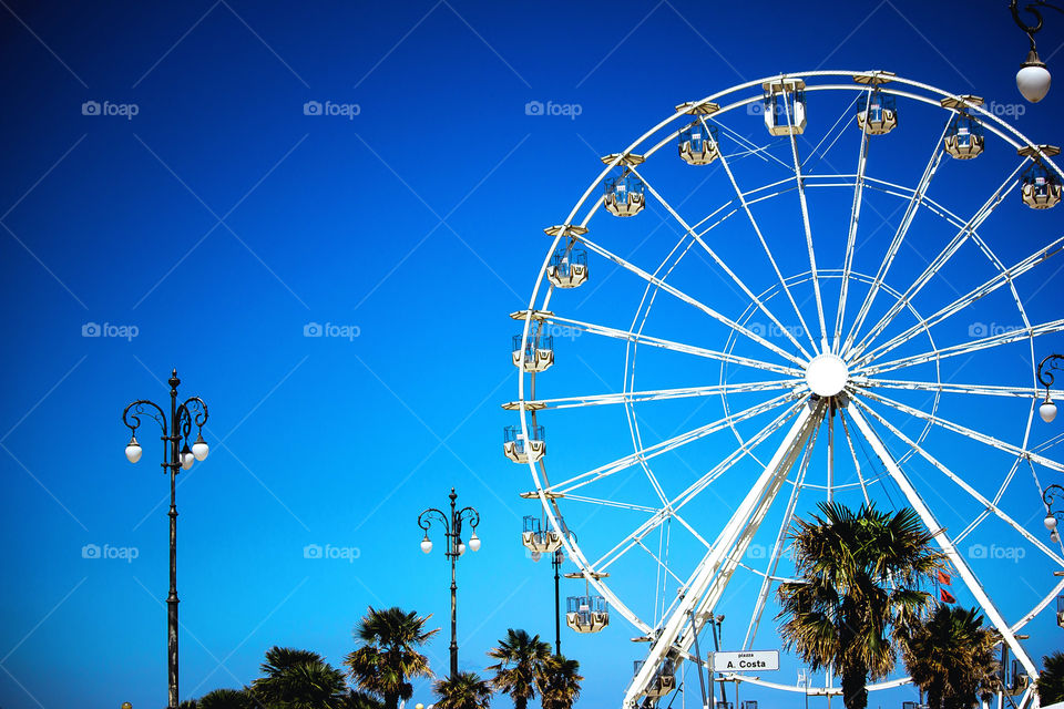 Panoramic wheel at the seaside, blue sky