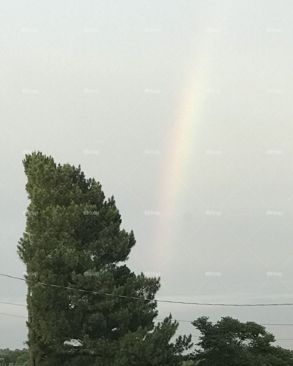 A very faint glimpse of a rainbow after the storm.