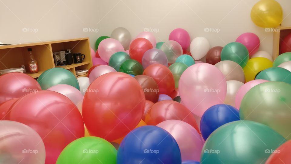Surprise to boss, boss room full of colorful balloos,