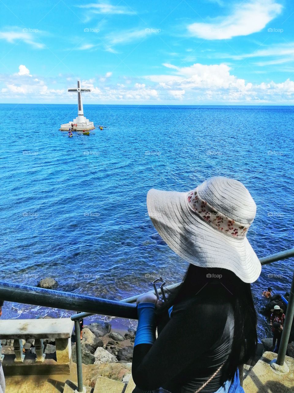 Looking at the huge cross of the Sunken Cemetery at Camiguin Island, Philippines.