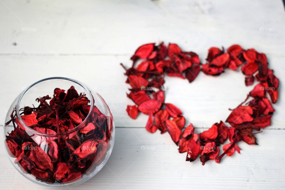 The figure in the form of hearts and flowers petals on a white background