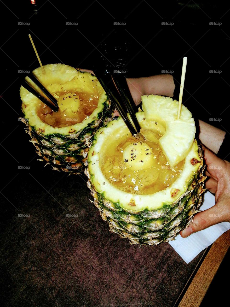 Indonesian drinks served in pineapples with gold leafs