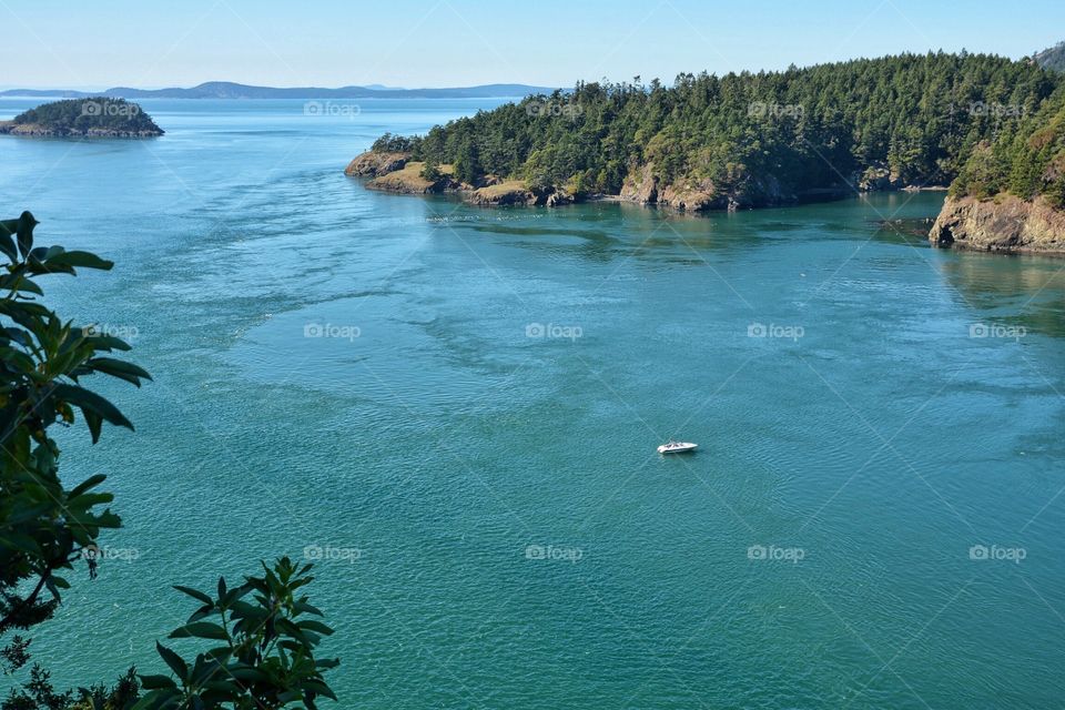 Lone boat in blue green water