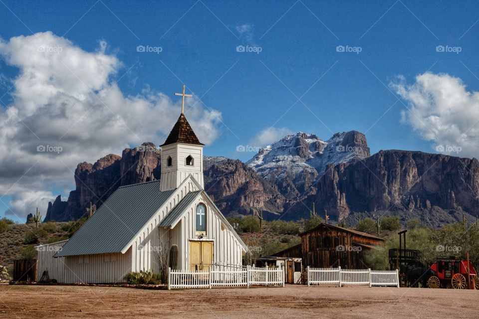Beautiful snowcapped peaks of the Superstition Mountains and a Church