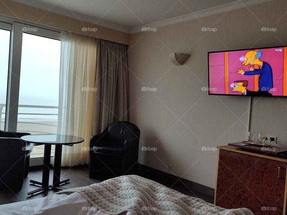 Morning in bed, sea view in front of the television.