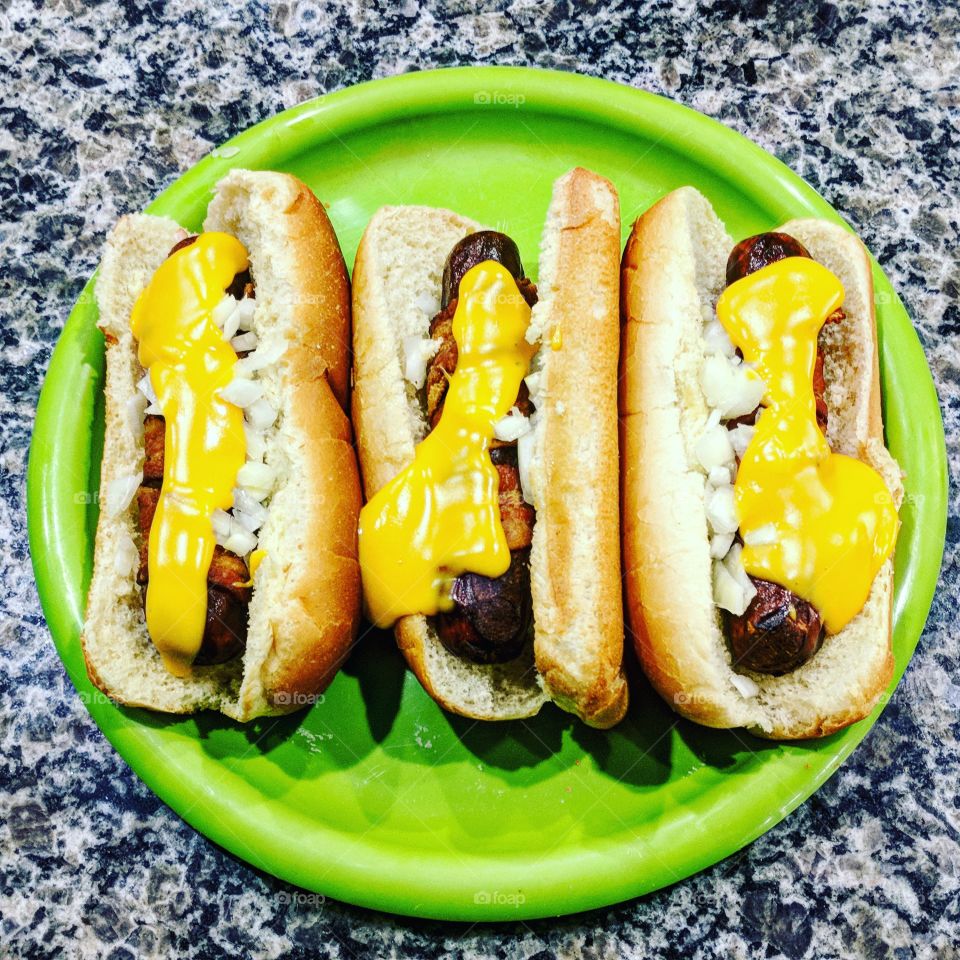 bacon wrapped deep fried hot dogs with cheese whiz and onions