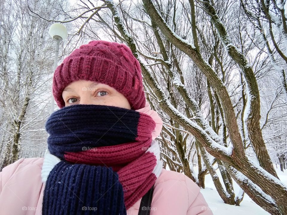 sweater weather girl portrait, walking in snowy park winter time