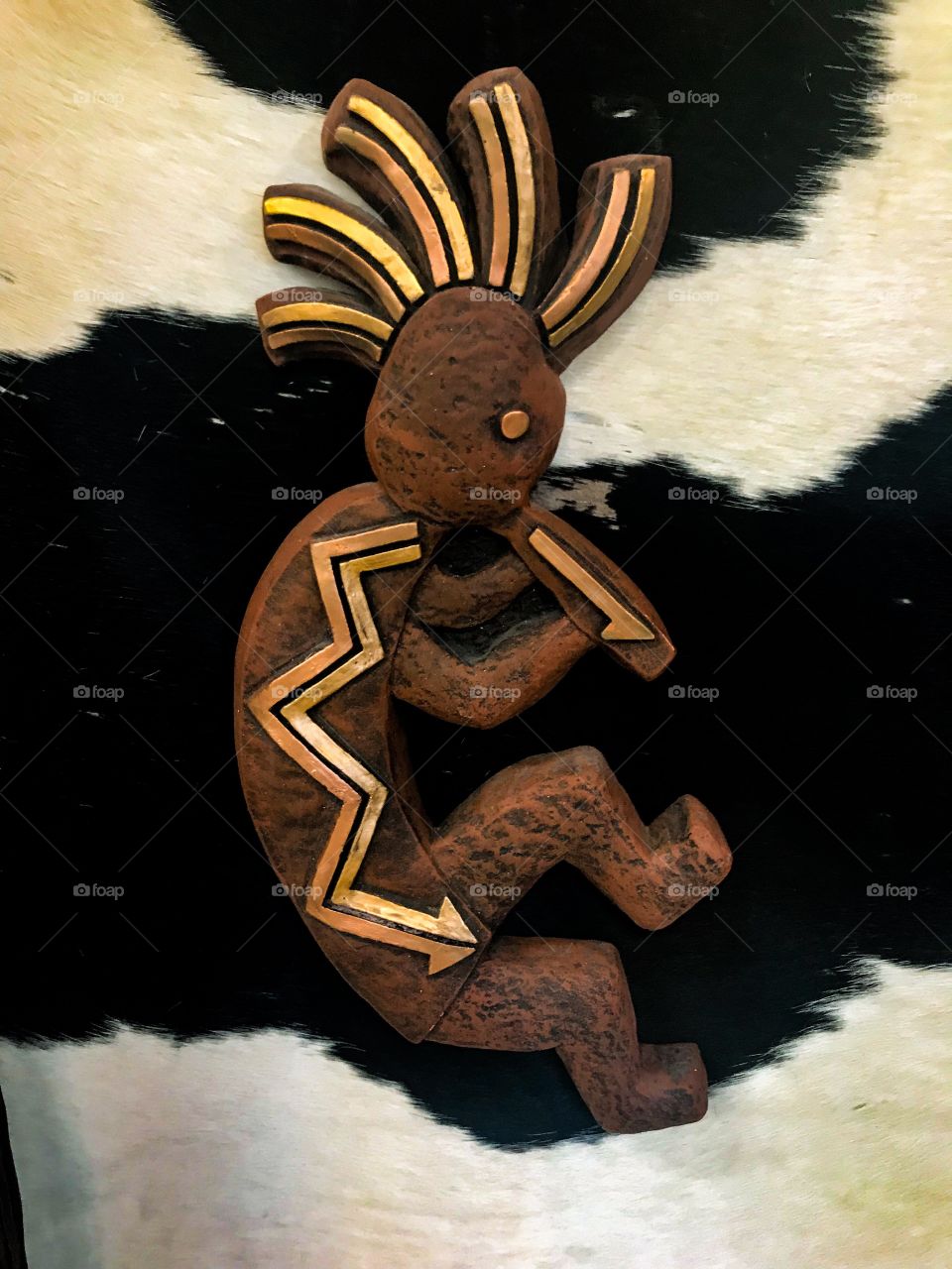 Wooden figure with cowhide in background...Top of the World Souvenirs and Gifts, New Mexico 