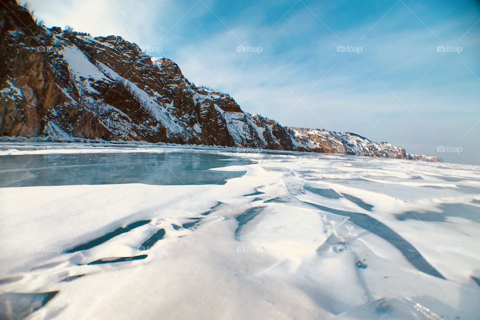 Baikal Lake contrast with big mountain along. Don't know how thick of the ice but van can drive on that WOW !