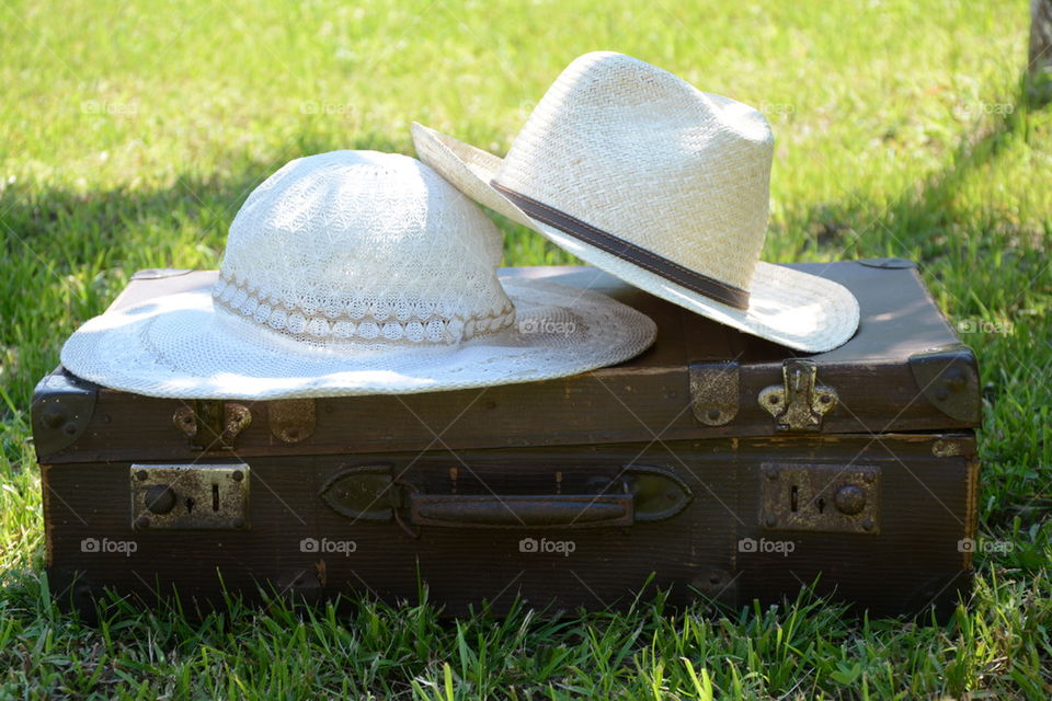 hats on suitcase