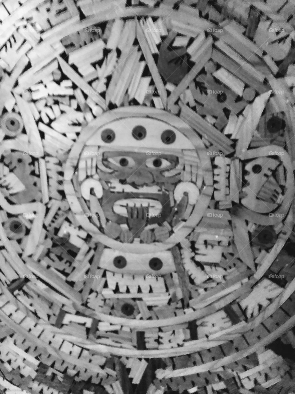 black and white of handmade wooden aztec calendar