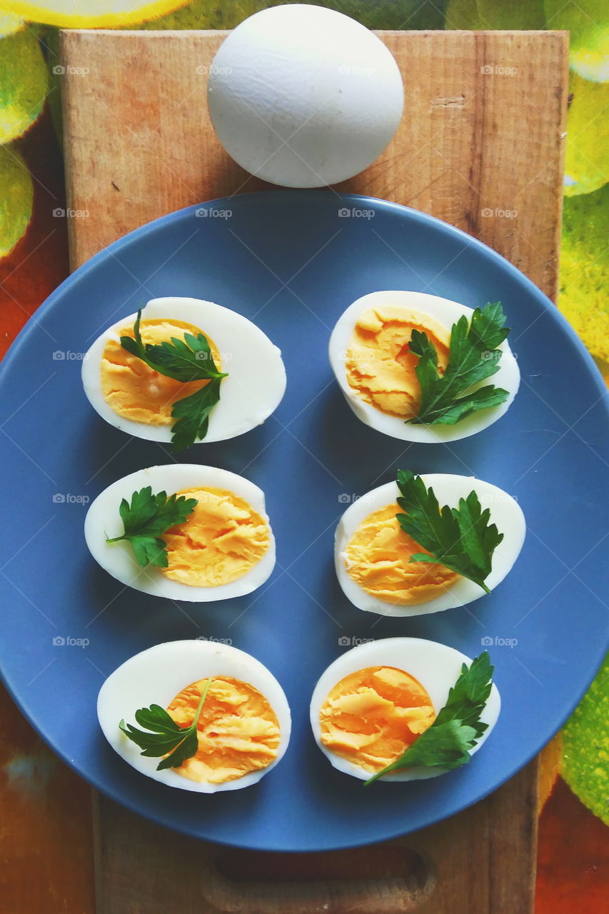 cut boiled eggs decorated with parsley