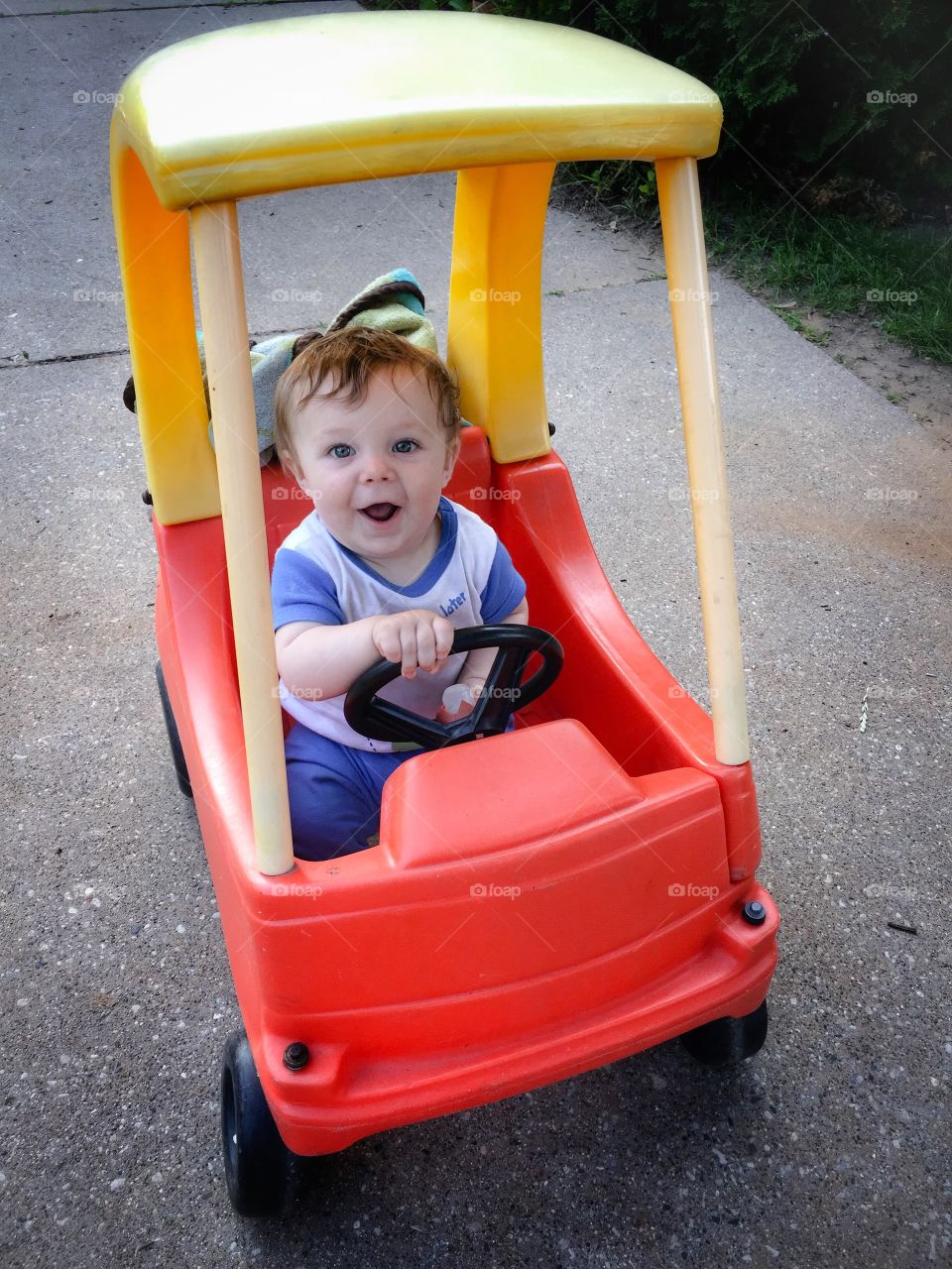 Cute boy travelling in toy car