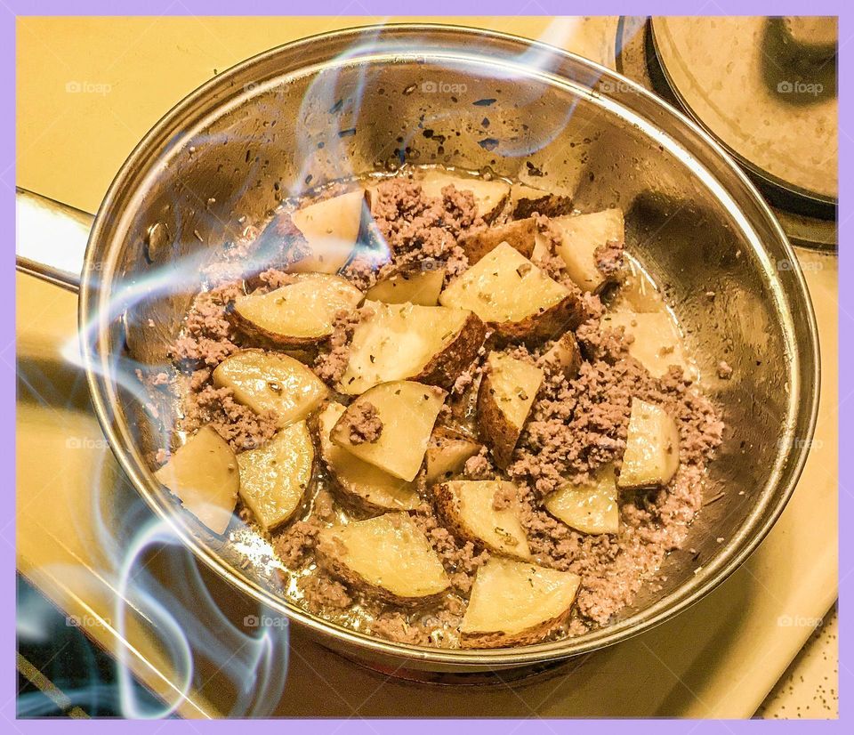 Late night cooking. It is potatoes and ground turkey prepared for dinner.
