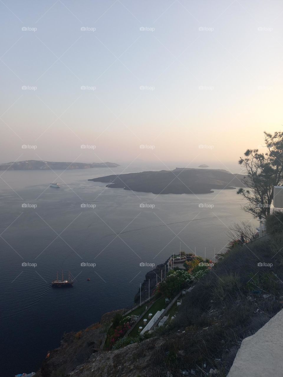 Summer in Santorini, Greece. There is the view of the Volcano of Santorini and next to it the little island called Thirasia.