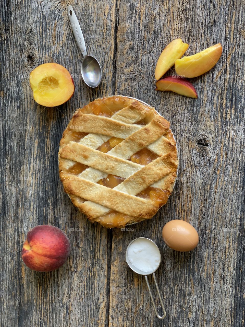 A freshly baked peach pie cooling down on a wooden table a perfect summertime treat!