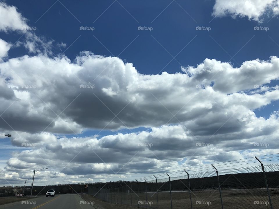 A beautiful view of clouds by the New London/Groton airport. 