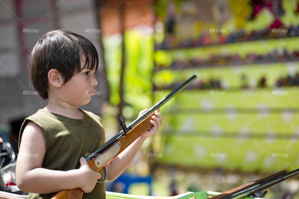 kid at funfair. shooting range for toys