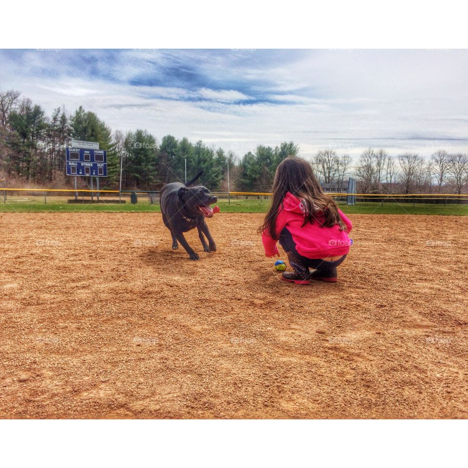 Play ball. Enjoying a beautiful spring day playing ball with our dog. 