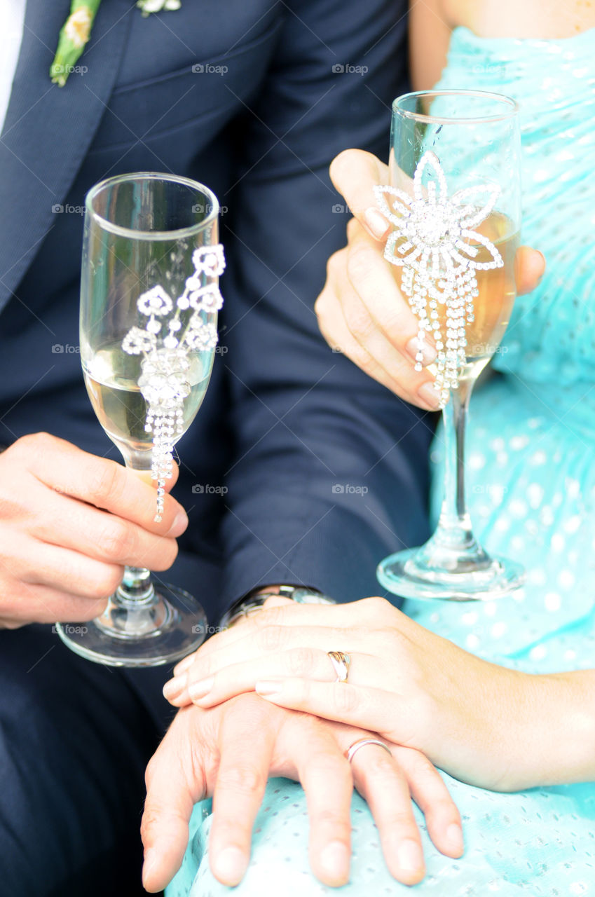 Close-up of couples with champagne glasses in hand