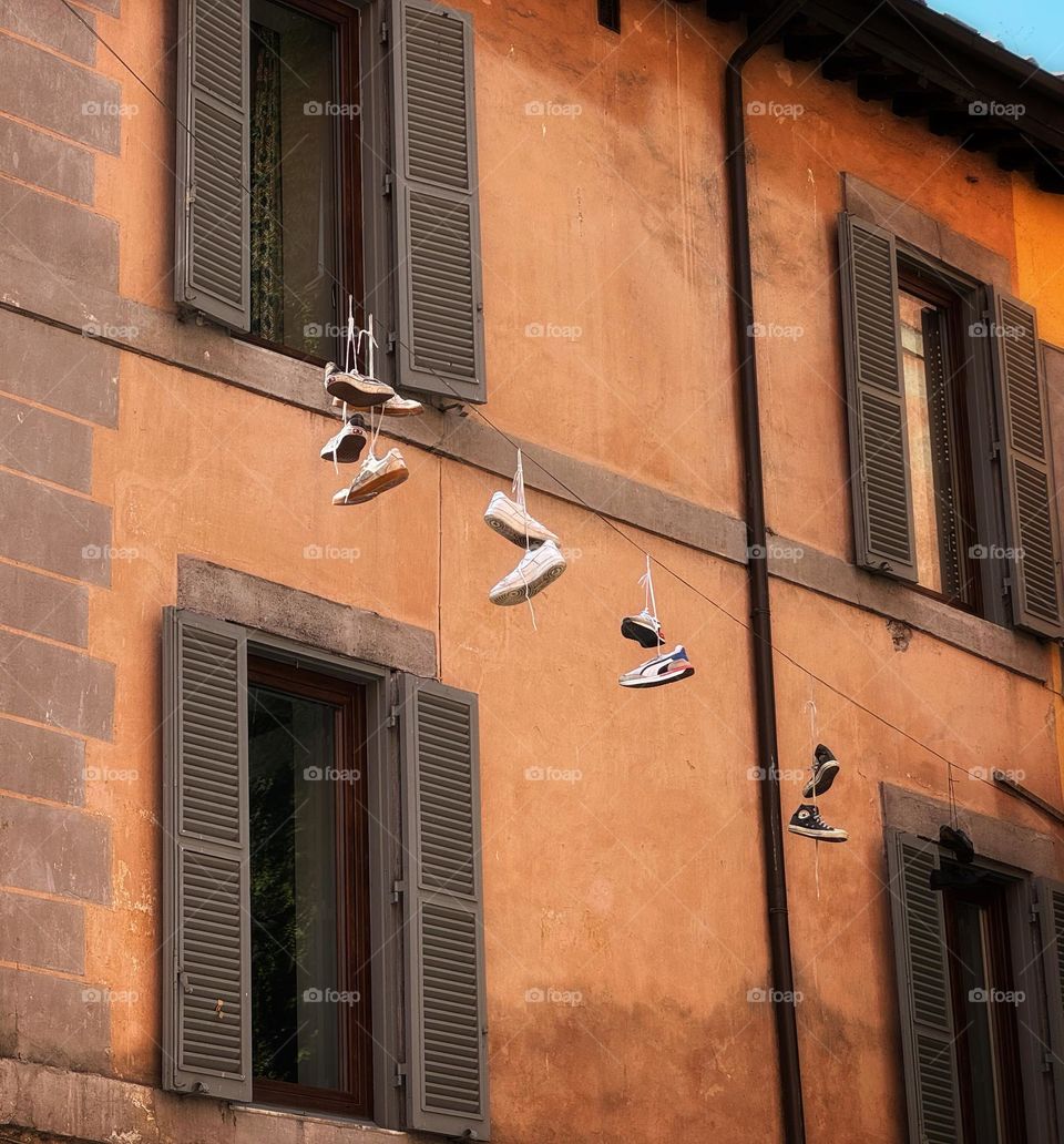 Shoes tossed over a wire in Rome
