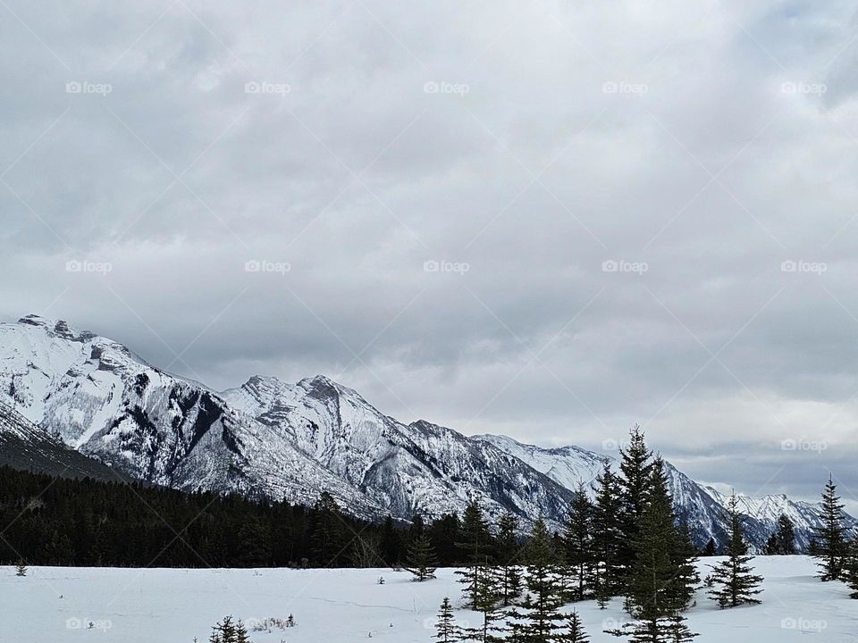 Snow covered mountains overlooking a frozen lake