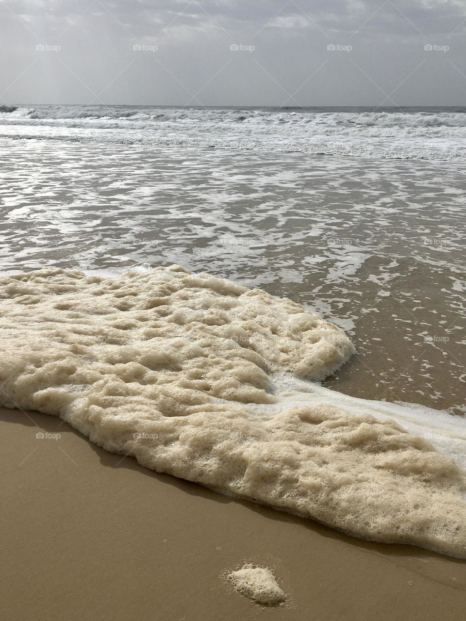 Sunny tide with foam