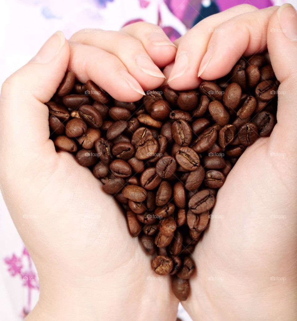 Person hand holding coffee beans