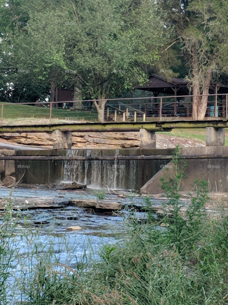 water fall under a  bridge