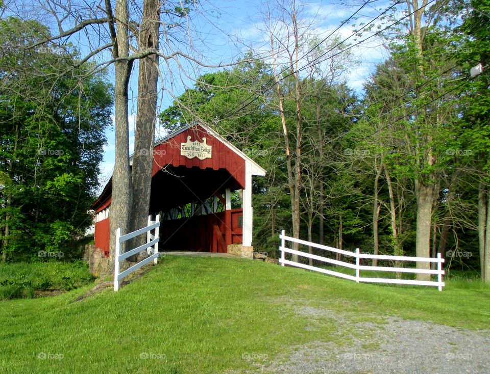 red covered bridge with fences