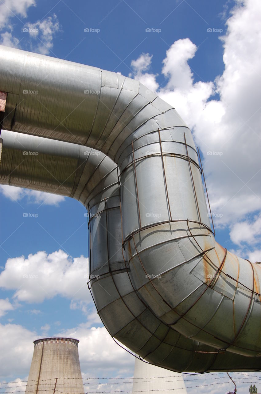 Large industrial ducting outside on partly cloudy day