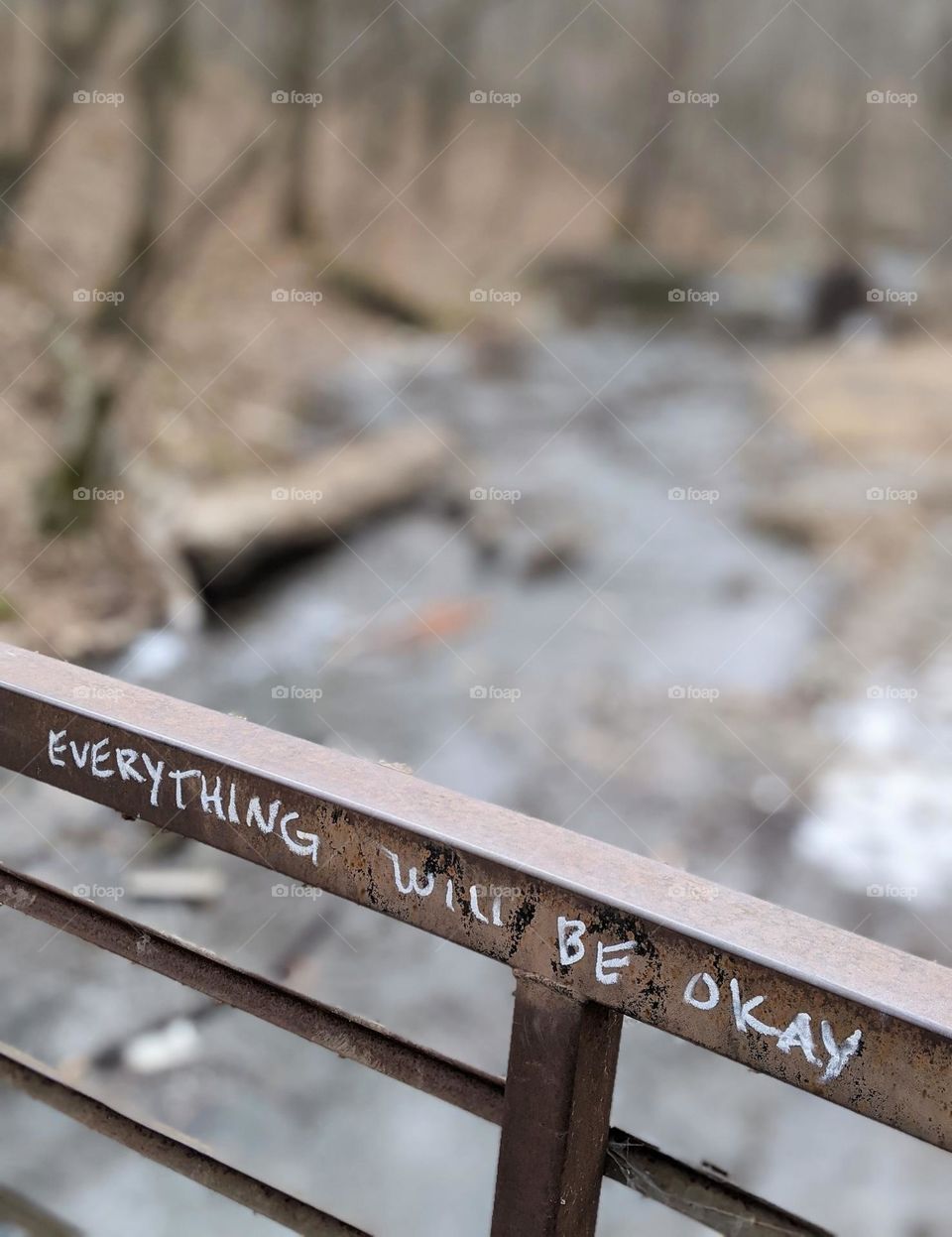 everything will be okay writing on bridge over river