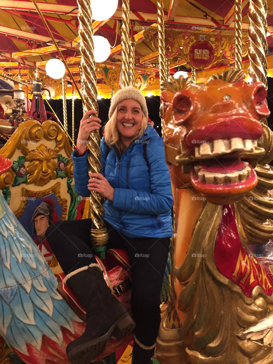 Woman on carousel smiling 