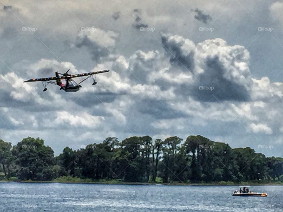 Aircraft flying over lake
