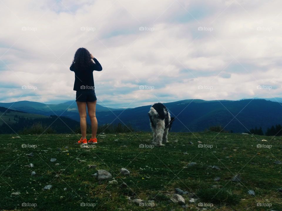 the girl taking a picture of the landscape