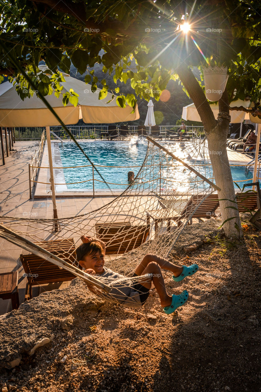 Boy enjoying hammock in sunny day