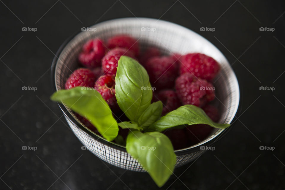 Raspberries and basil,morning bowl in Spring,only daylight.
