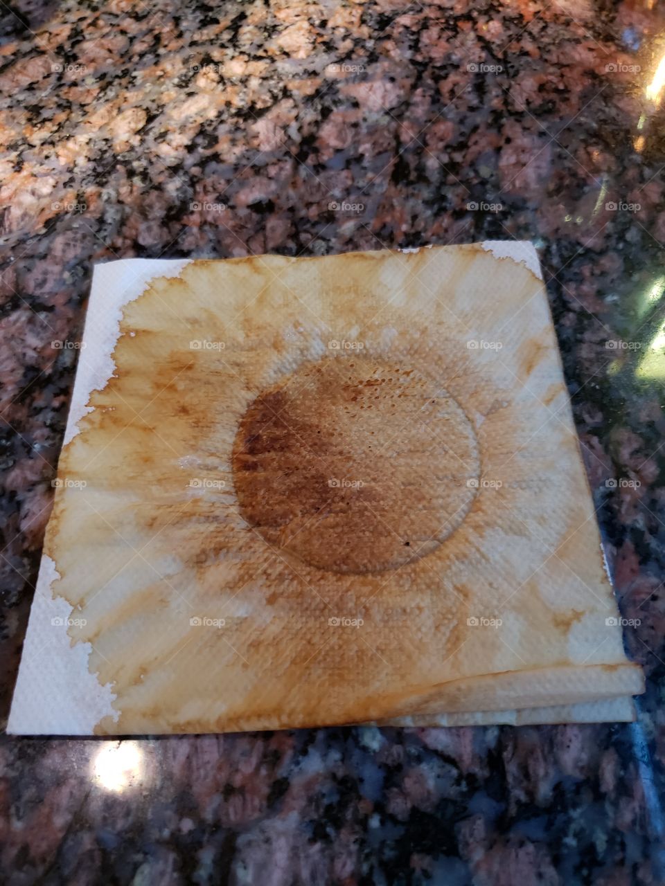 Vietnamese coffee stain on napkin, looks like sunflower