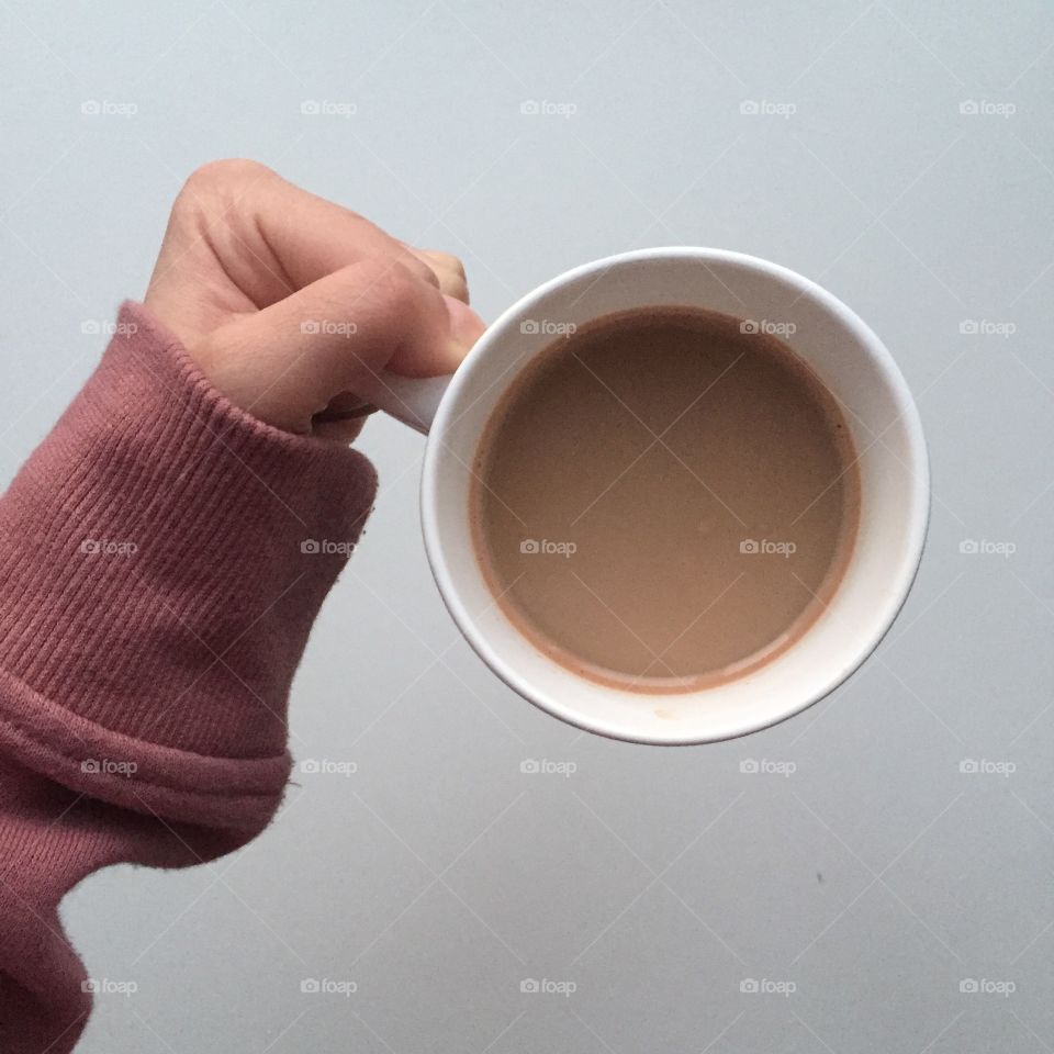 Holding a warm cup of coffee