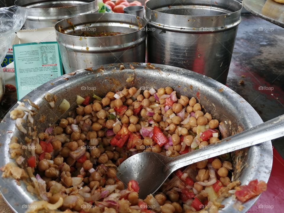 Chole kulche or chickpeas mix with tomato, chutney, lemon, green chilli, salt, and masala serve with tikii or potato tikki and sometimes these mix chickpeas serve. It is famous Street  fast food of India.