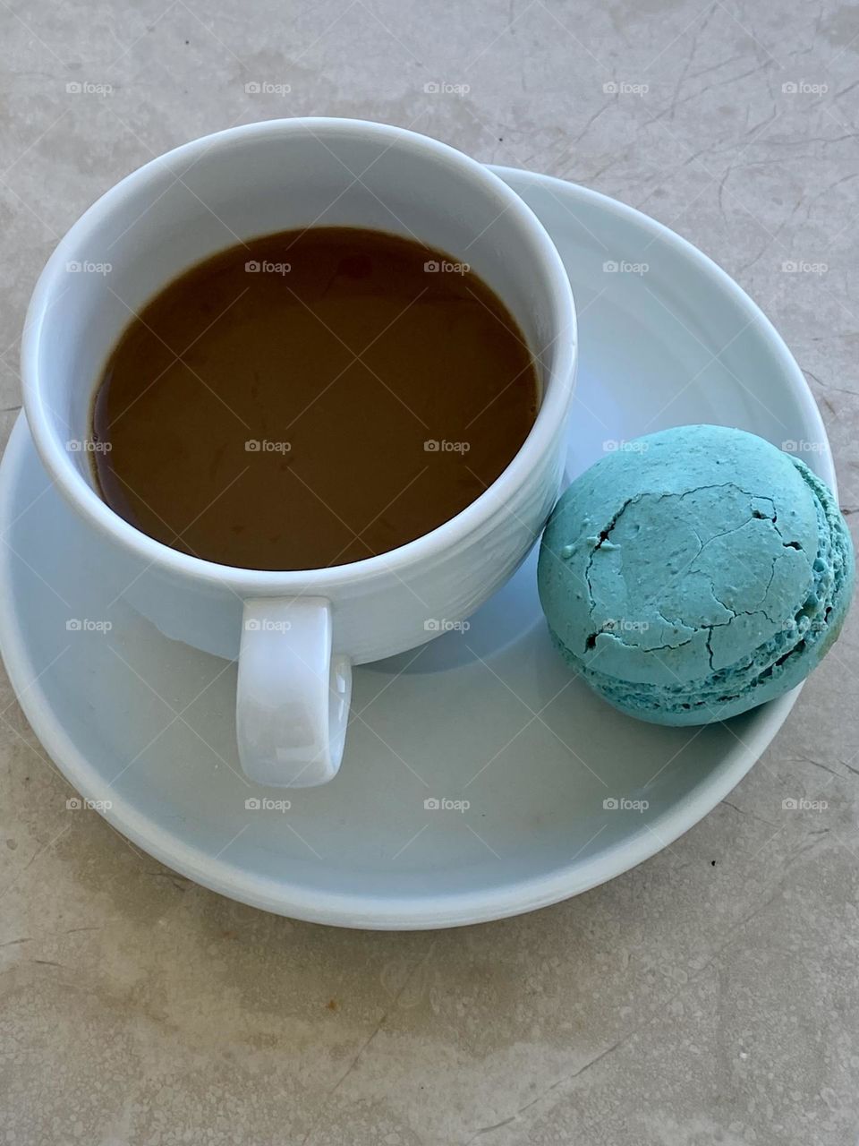Cup with coffee and macaron 