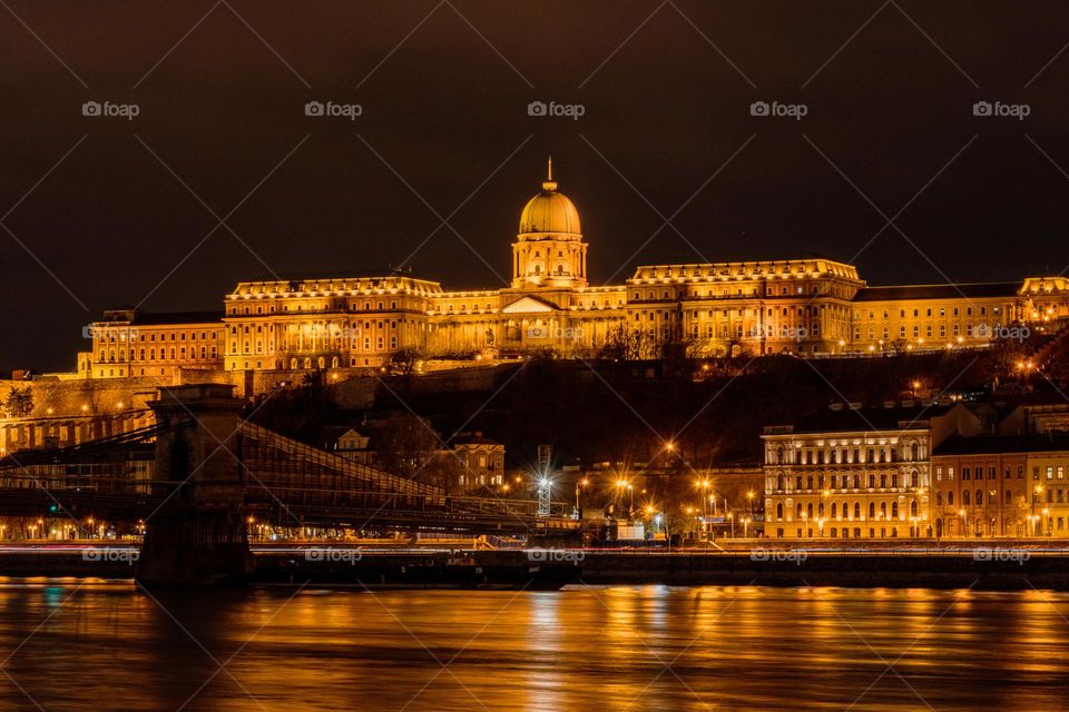 Night photo of illuminated Buda castle above Danube rirver in Budapest, Hungary