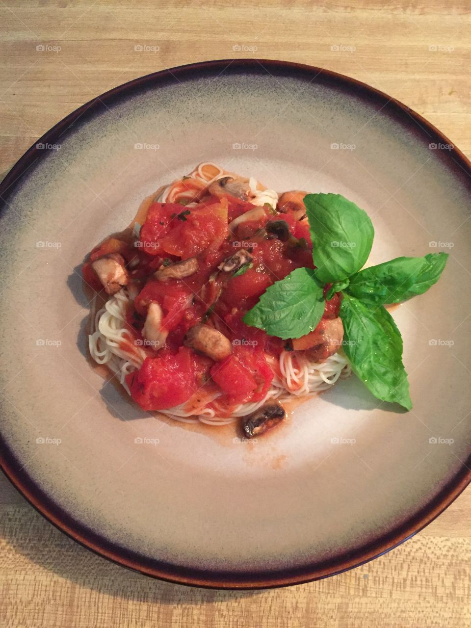 Angel hair pasta with tomatoes, mushrooms and basil