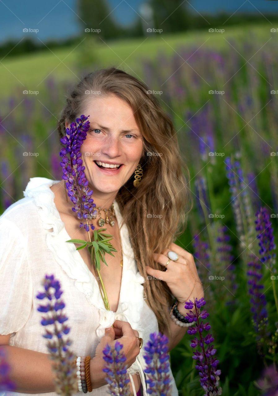 Happy woman with lupine flower