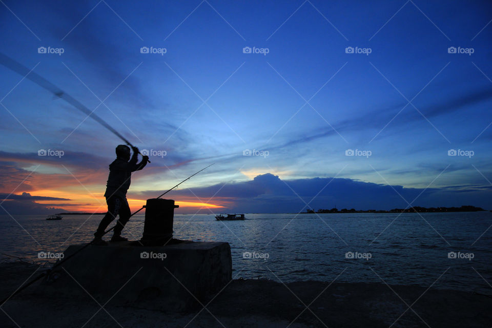 Fishing in sunset in pramuka island